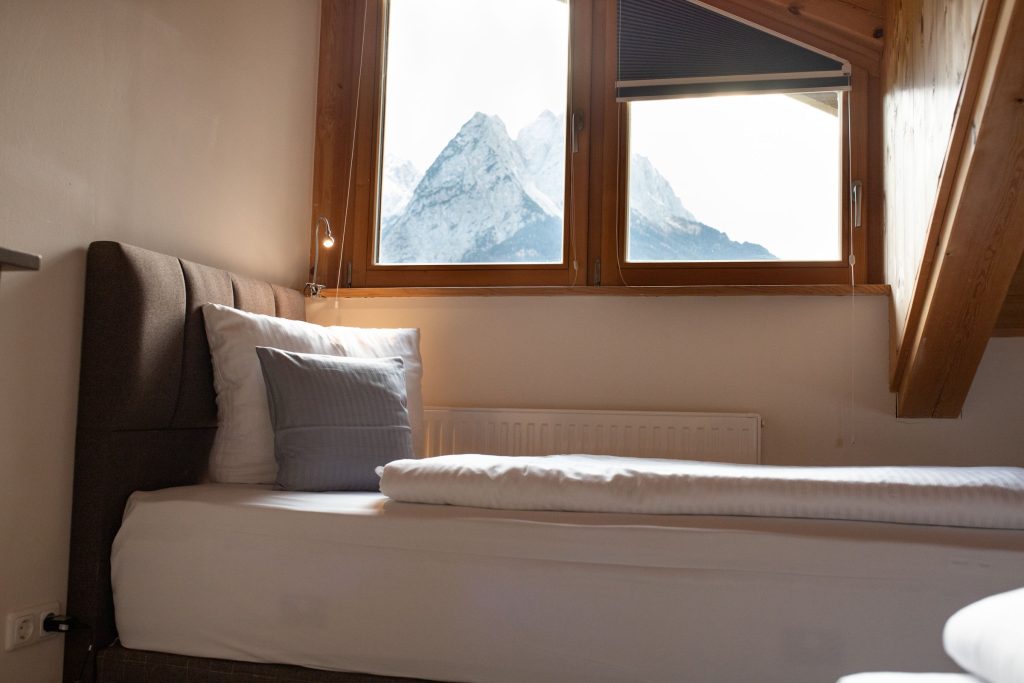 Einzelbett mit Ausblick auf die Alpen in Ferienwohnung in Garmisch-Partenkirchen