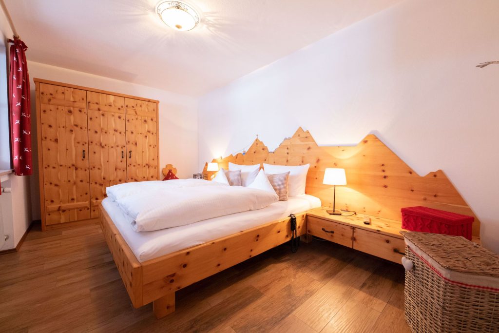 Schlafzimmer mit Doppeltet in Holz-Optik in Ferienwohnung in Garmisch-Partenkirchen