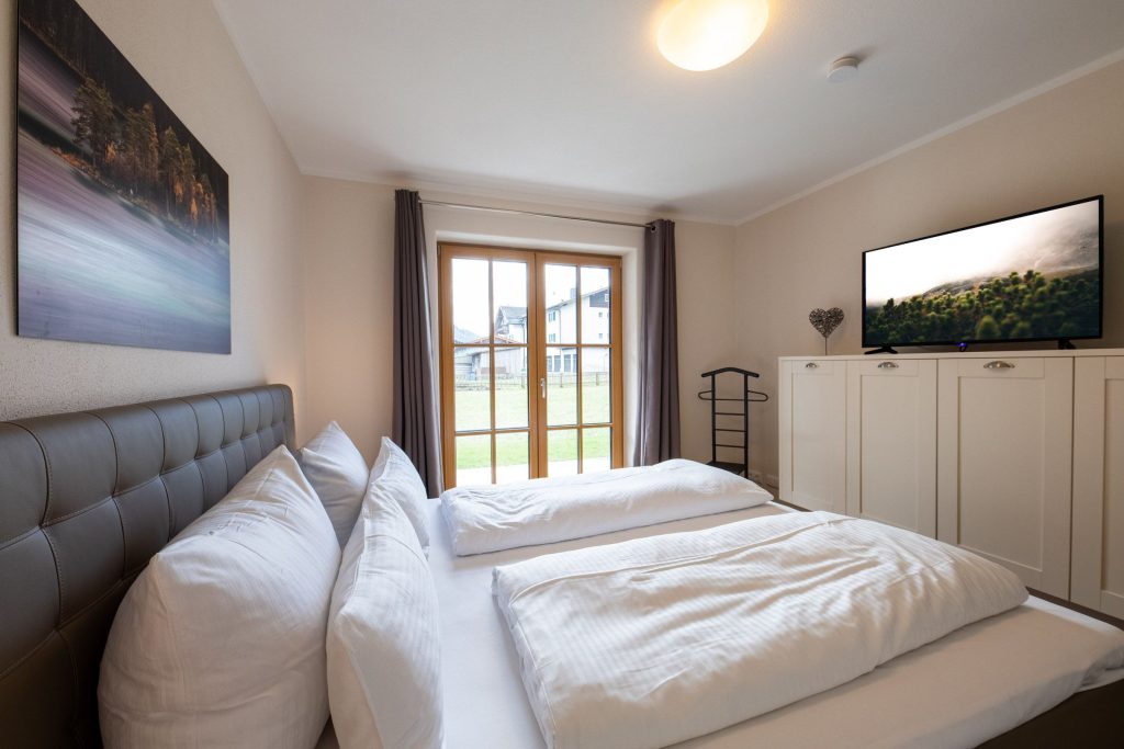 Doppelbett mit Fernseher in Ferienwohnung in Garmisch-Partenkirchen