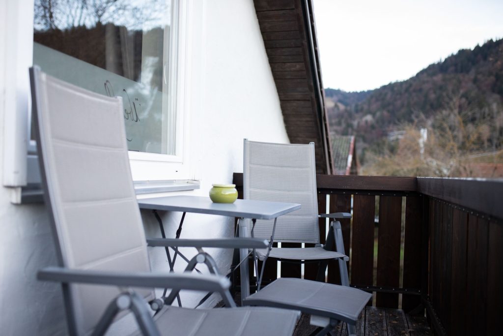 Balkon mit grauen Stühlen in Ferienwohnung in Garmisch-Partenkirchen